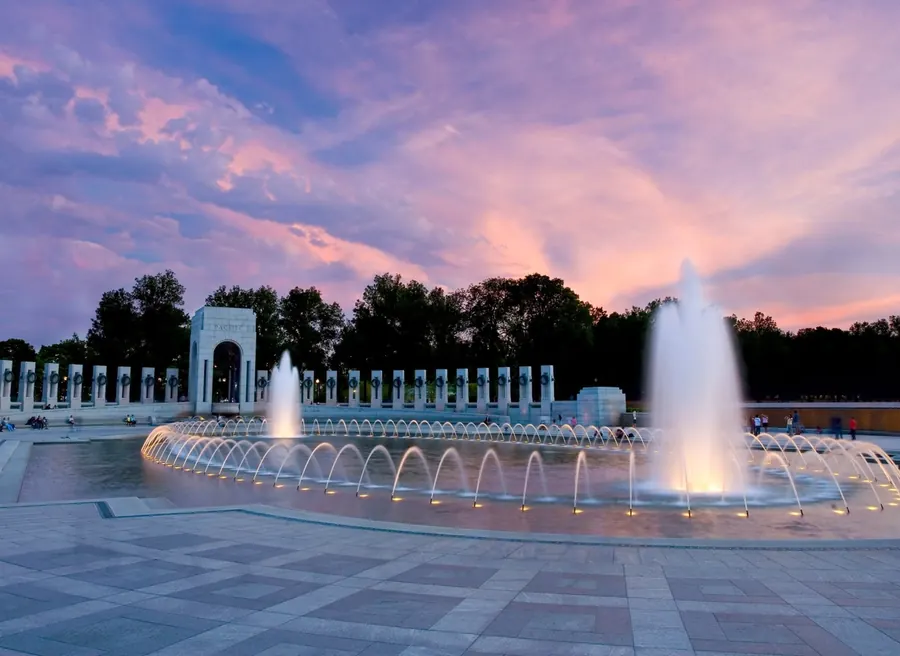 The World War II Memorial fountains in Washington, DC, at dusk.